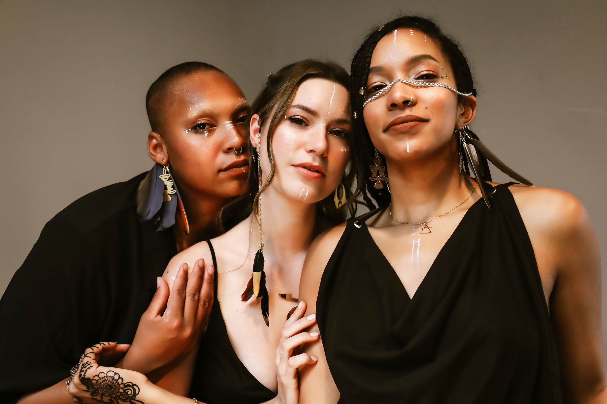 Three Models wear Rael Cohen Jewelry Feather Ear Cuffs and Gold Geometric Necklaces